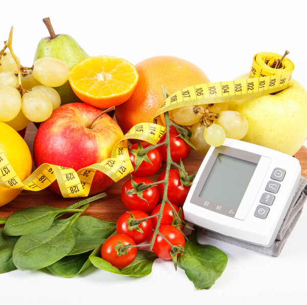 Монитор артериального давления, свежие спелые фрукты с овощами и сантиметром, здоровый образ жизни
