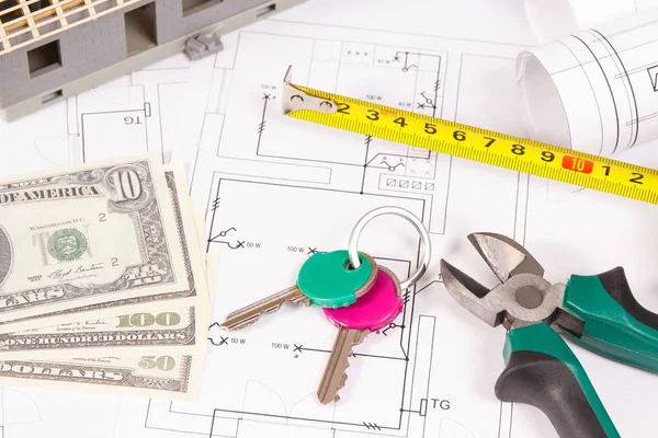 Home keys, money, electrical diagrams and work tools for engineer jobs, building home cost concept