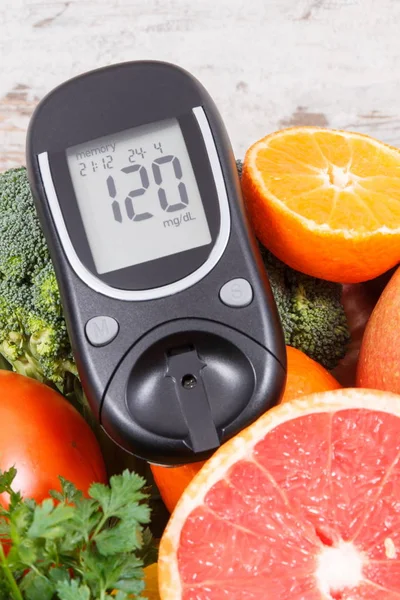 Glucose meter with healthy fruits and vegetables. Checking sugar level, diabetes, diet and slimming concept