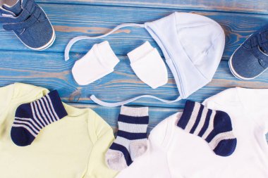 Clothes for little baby boy, concept of extending family clipart