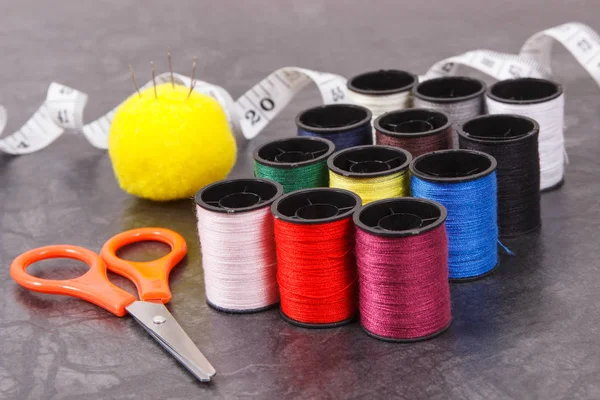 Spools of thread, needle, tape measure and scissors. Accessories for needlework — Stock Photo, Image