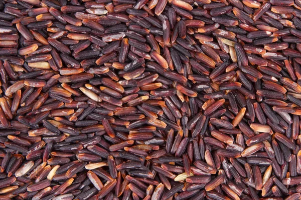 Hromadu černé rýže jako pozadí, zdravé bezlepkové potraviny koncept — Stock fotografie