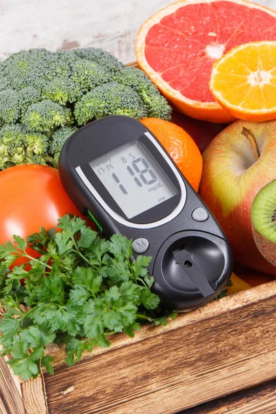 Glucose meter with healthy fruits and vegetables. Checking sugar level, diabetes, diet and slimming concept