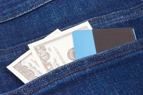 Currencies dollar and credit card in jeans pocket. Choice between cashless or cash payment — Stock Photo, Image