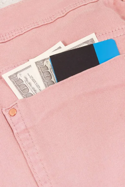 Currencies dollar and credit card in pants pocket. Choice between cashless or cash payment — Stock Photo, Image