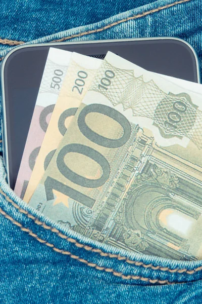 Waluty euro i smartphone w kieszeni dżinsy. Koncepcja płatności bezgotówkowych lub pieniężnych — Zdjęcie stockowe