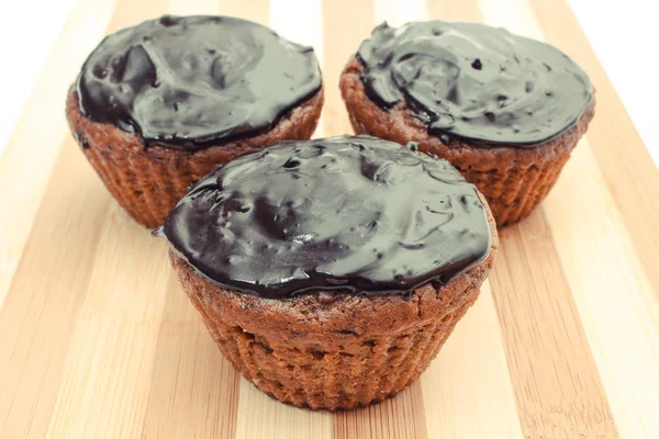 Fresh baked chocolate muffin on chopping board. Delicious dessert