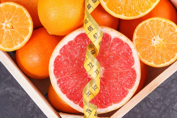 Centimeter with healthy citrus fruits containing minerals and vitamins. Dieting and slimming concept — Stock Photo, Image