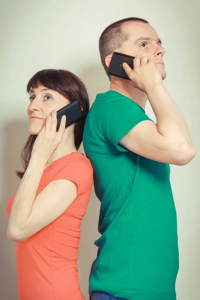 Frau und Mann sprechen am Handy über verschiedene Probleme oder Dinge — Stockfoto