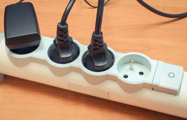 Electrical plugs with cords connected to power strip. Concept of energy saving — Stock Photo, Image