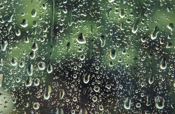 Dripping down drops of rain on glass — Stock Photo, Image