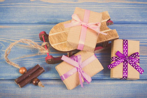 Vintage photo, Wooden sled and wrapped gifts with ribbons for Christmas or other celebration — Stock Photo, Image