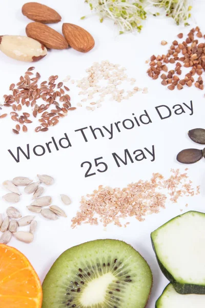 Nutritious ingredients and inscription World Thyroid Day 25 May on white background. Healthy food containing vitamins. Problems with thyroid concept