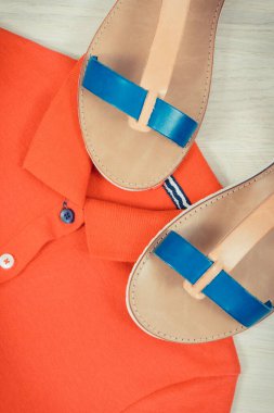 Kadın derisi sandaletler ve kırmızı gömlek, rahat giysi kavramı.