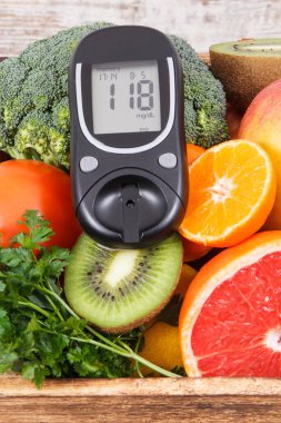 Glukometre ve şeker seviyesi ve sebzeli doğal meyve. Şeker hastalığı ve mineral ve vitamin içeren sağlıklı yiyecekler.
