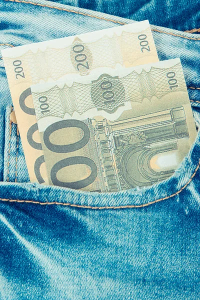 Money in pocket of blue pants. Finance and banking concept