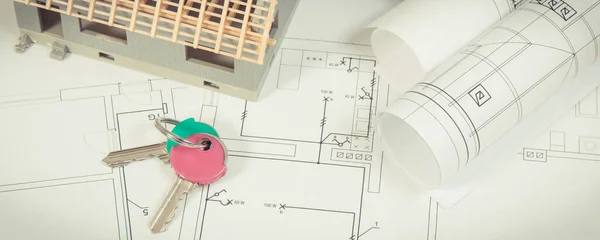 House under construction, home keys and electrical diagrams for use in engineer jobs, building home concept