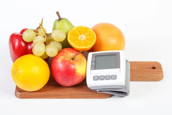 Blood pressure monitor and fresh fruits with vegetables, healthy lifestyle and prevention of hypertension concept