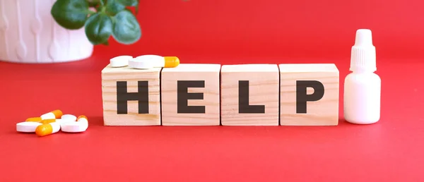 Слово Help Складається Дерев Яних Кубиків Червоному Тлі Медичними Препаратами — стокове фото