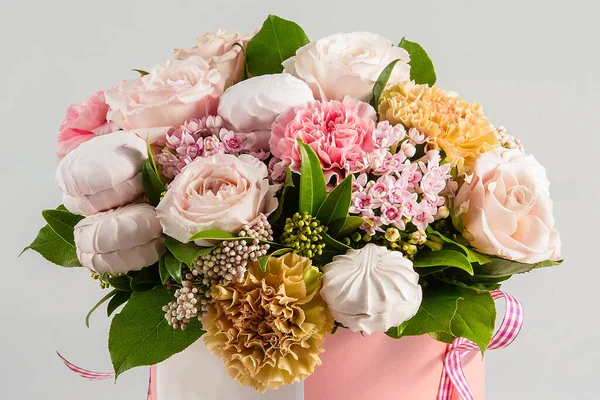 a bouquet of flowers and sweets is in a gift box, top view