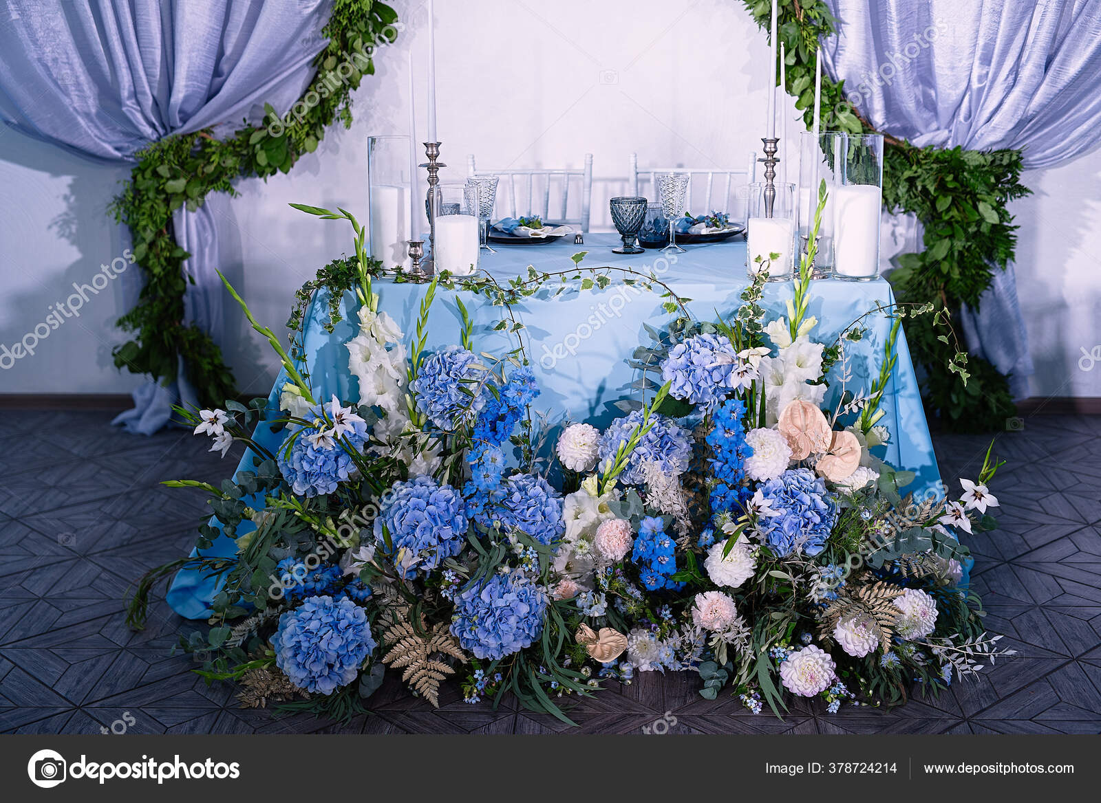 Flower Arrangement Table Blue Tablecloth White Candles Dishes Bouquet