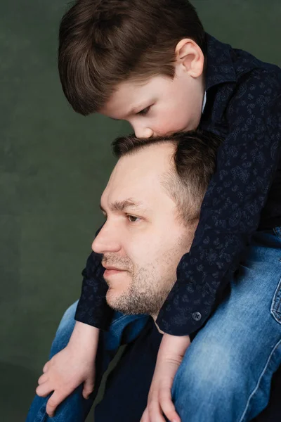 relationship of dad with son, child hugs dad and kisses