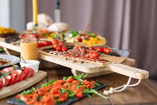 tasty and healthy food lies on  table, fish and vegetables are beautifully sliced, beautiful dishes on  wooden table, selective focus