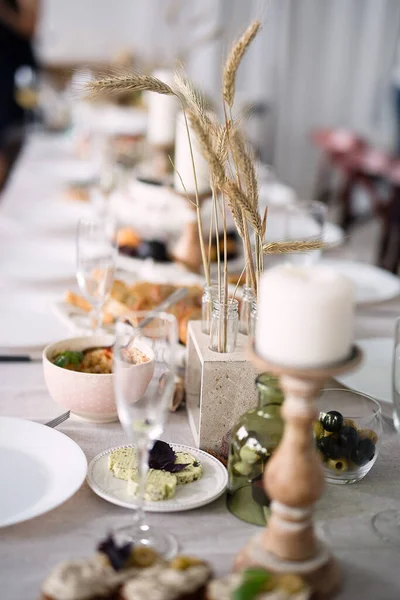フェスティバルは素朴なスタイルのテーブル キャンドル 白いテーブルクロスに立つ料理 ストック写真