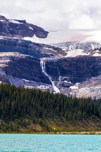 Bow Glacier with waterfalls and Bow Lake in Banff National Park, Alberta, Canada. Bow Glacier is an outflow glacier from the Wapta Icefield along the Continental Divide, and runoff from the glacier supplies water to Bow Lake and the Bow River.