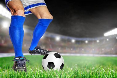 Futbol ile eylem futbolcu parlak açık stadyum yaktı. Ön plan ve futbol topu alan arka plan ve kopya alanı üzerine sığ derinliği ile odaklanmak.