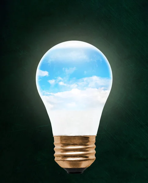 Blue sky inside floating light bulb with copy space. Concept of ecology, environmental conservation; green alternative.