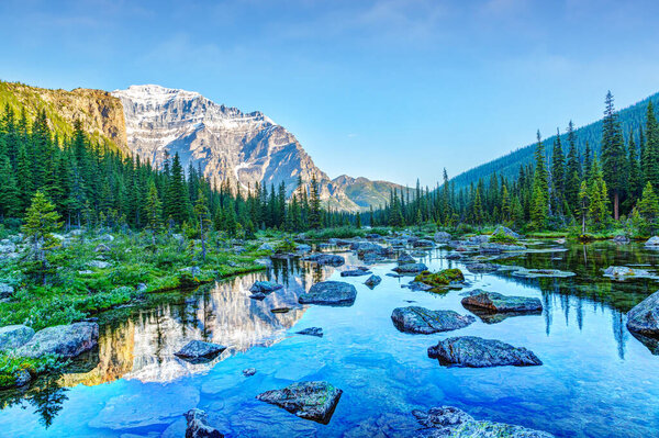 Moraine Lake hike with Mount Temple reflecting off Consolation Lakes at Banff National Park near Lake Louise in Alberta, Canada.