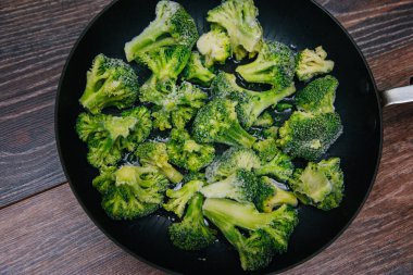Frozen green cabbage, semi-finished product in a pan.