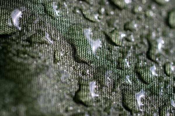 Water drops on the fabric. Water drops on green background. Condensate. Water drops background.Luxury green background