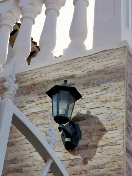 lantern on the wall of the house at the stairs with a balustrad