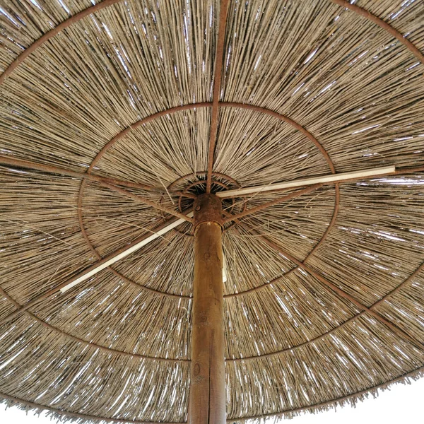 summer straw umbrellas for the beach and cafes, the tourist season of the Mediterranean Sea