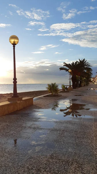 Imbarco Sul Mare Dopo Pioggia Tramonto Una Pozzanghera Sulla Strada — Foto Stock