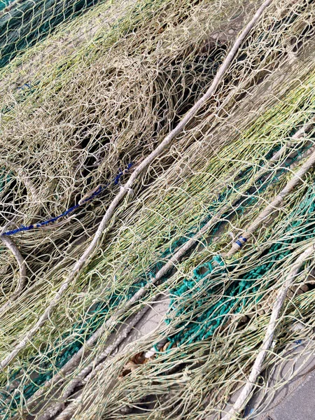 fishing nets and tackles drying on the pavement