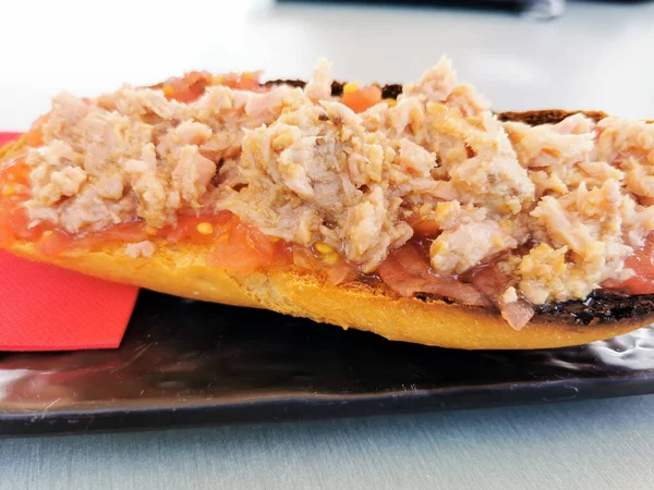 typical Spanish breakfast, bread with tuna and tomato