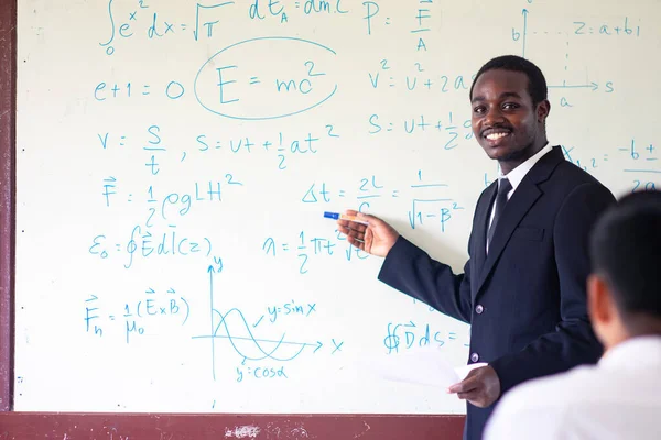 African teacher teaching science in the classroom
