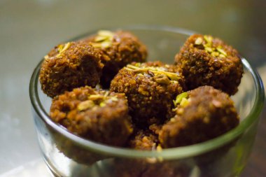 Fresh Homemade ladoo or laddu, made by bread crumbs with pistachio on it, with selective focus