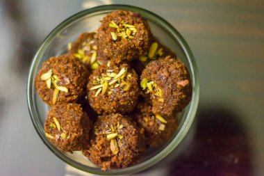 Fresh Homemade ladoo or laddu, made by bread crumbs with pistachio on it, with selective focus clipart