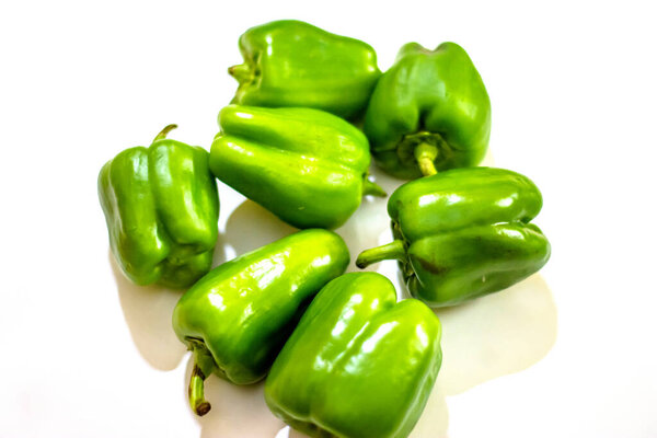 Fresh green capsicum or bell pepper isolated on a white background