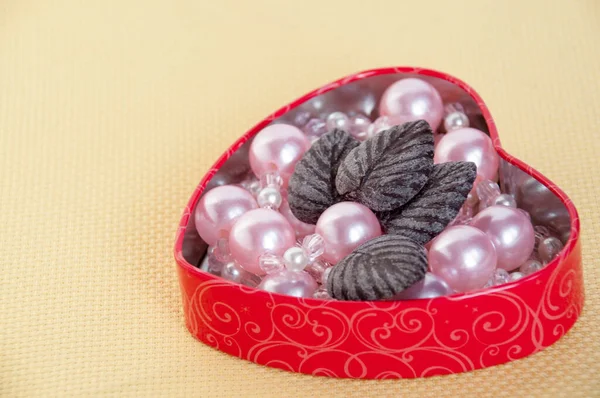 Heart Pink Pearls Chocolate Leaves Yellow Background — Stock Photo, Image
