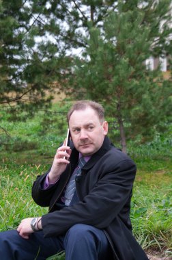 Dışarıda telefonla konuşan adam.