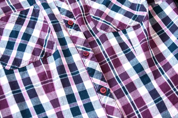 Background of plaid shirts, pockets, and clasp