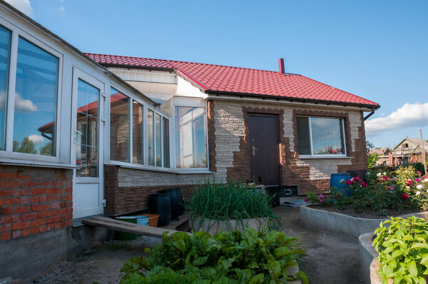 Beautiful country house with blooming garden on a summer day