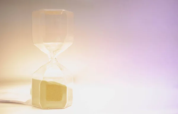 Sand running through the hourglass measuring the passing time in a countdown to a deadline, Hourglass time concept for rush and run out of time., business deadline.
