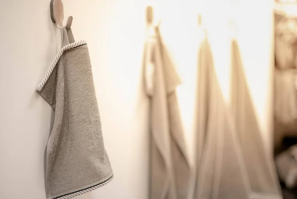 The grey towels hanging on the stand in supermarket. For the customer choose for use inside the house, Showcase the color with the decorate interior store.