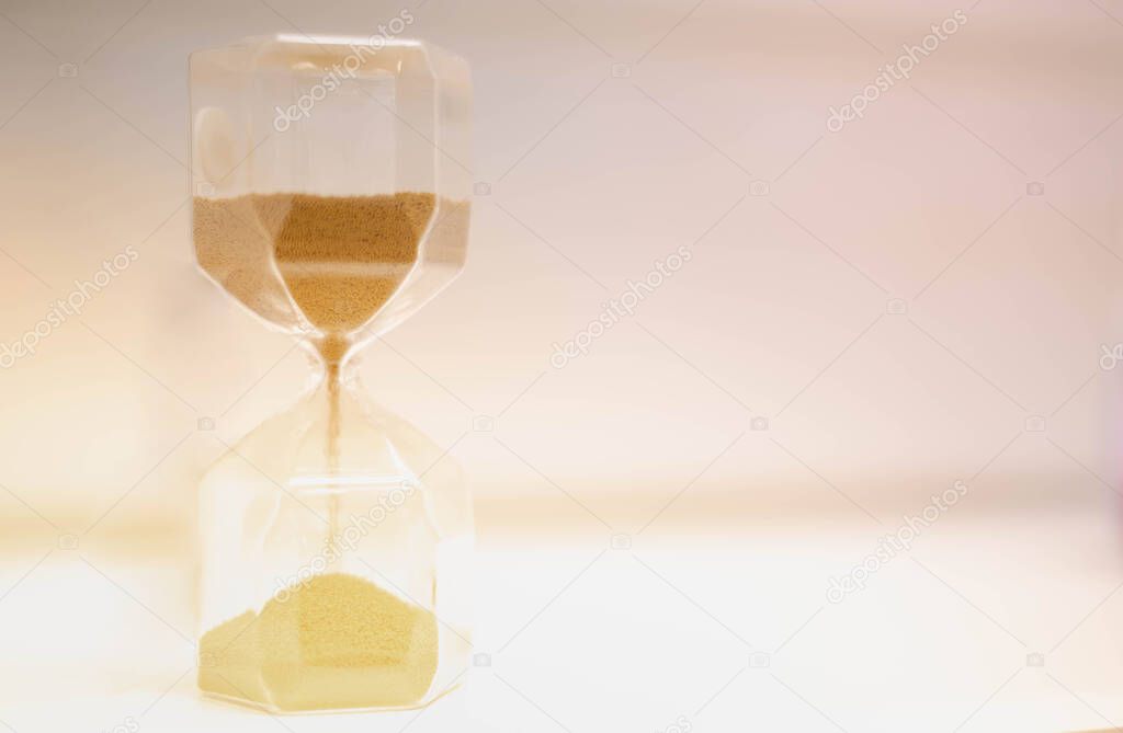 Sand running through the hourglass measuring the passing time in a countdown to a deadline, Hourglass time concept for rush and run out of time., business deadline.